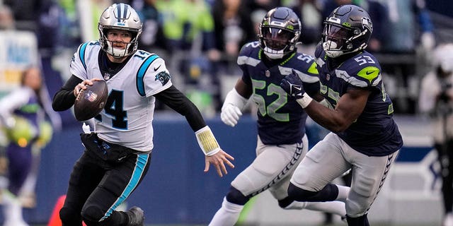 Carolina Panthers quarterback Sam Darnold (14) runs down the field against the Seattle Seahawks during the second half of an NFL football game, Sunday, Dec. 11, 2022, in Seattle.