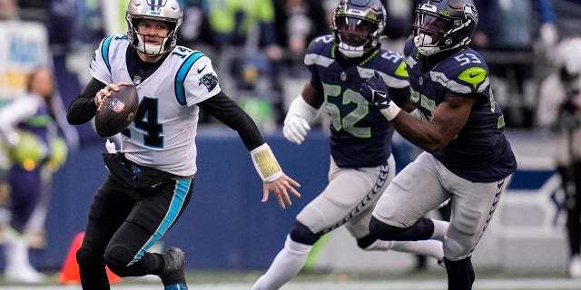 Carolina Panthers quarterback Sam Darnold (14) runs down field against the Seattle Seahawks during the second half of an NFL football game, Sunday, Dec. 11, 2022, in Seattle.