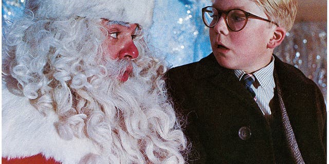 Peter Billingsley sits on Santa's lap in a scene from the film 