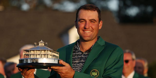 Scottie Scheffler poses with the trophy after winning the Masters at Augusta National Golf Club on April 10, 2022, in Augusta, Georgia.