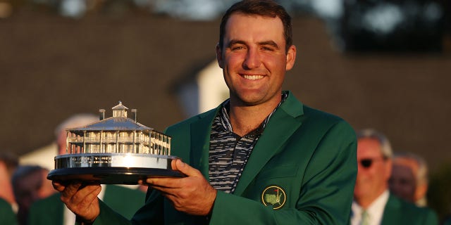 Scottie Scheffler poses with the Masters trophy during the Green Jacket ceremony after winning the Masters at Augusta National Golf Club on April 10, 2022, in Augusta, Georgia.