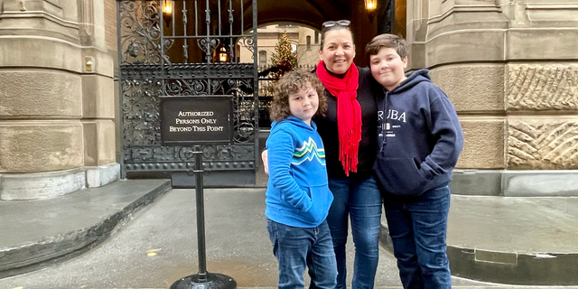 The entrance to The Dakota in Manhattan, where John Lennon was murdered in 1980. It's a pilgrimage site to this day. "This place radiates importance," Ethan Doyle, right, 12, of Philadelphia, told Fox News Digital this week. He's pictured with brother Brodie and mom Monique Doyle.