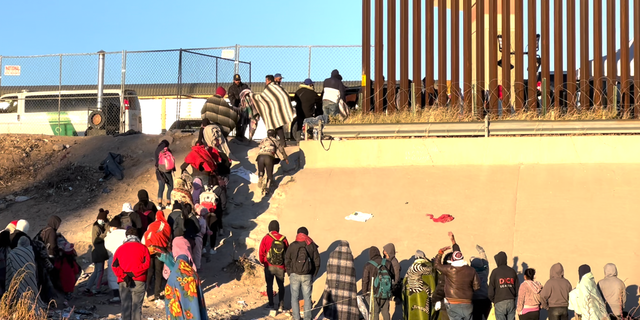 Migrants at the front of the line are processed for entry by U.S. Customs and Border Protection.