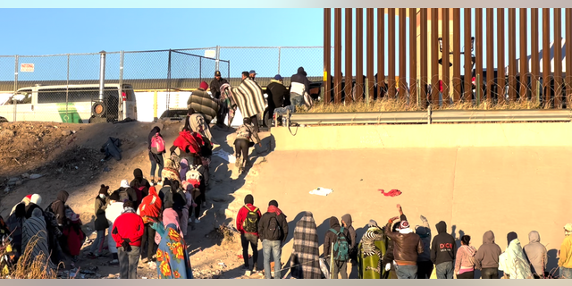 Migrants standing in line at the Border