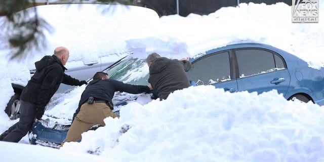 Images captured by Fox News Digital show people removing snow from a blue Honda sedan bearing Arizona plates and then driving it away from the tow lot on Dec. 20, 2022. The vehicle was one of the cars that was towed away from the crime scene and moved to the lot weeks earlier.