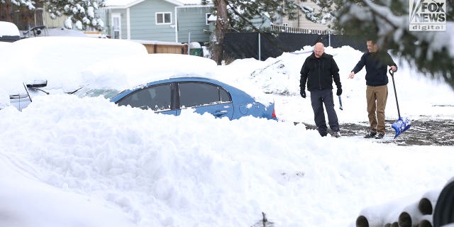 Images captured by Fox News Digital show people removing snow from a blue Honda sedan bearing Arizona plates and then driving it away from the tow lot on Dec. 20, 2022. The vehicle was one of the cars that was towed away from the crime scene and moved to the lot weeks earlier.