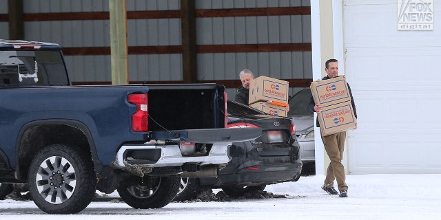 Images captured by Fox News Digital show people retrieving several boxes from a Moscow facility where the victims' belongings were being stored after the tragedy in Moscow, Idaho, Dec. 20, 2022.