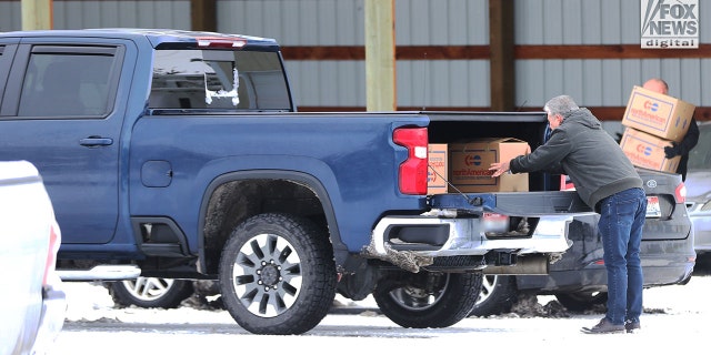 Images captured by Fox News Digital show people retrieving several boxes from a Moscow facility where the victims' belongings were being stored after the tragedy in Moscow, Idaho, Dec. 20, 2022.