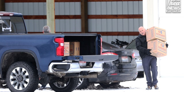 Images captured by Fox News Digital show people retrieving several boxes from a Moscow facility where the victims' belongings were being stored after the tragedy in Moscow, Idaho, Dec. 20, 2022.