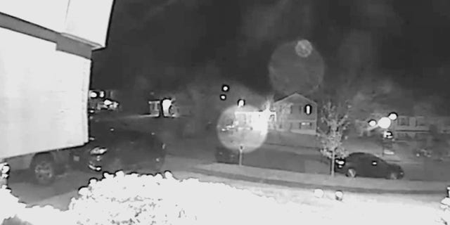 In footage captured on a Ring doorbell, a person (circled in the center) can be seen running toward a house while shooting multiple rounds at it.