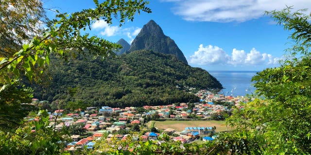 A British man was killed and one was wounded in a St. Lucia bar shooting late Saturday night. Pictured: A view of the Pitons, twin volcanic spires located in Saint Lucia. They are on a world heritage site which occupies an area of about 7,190 acres near the town of Soufriere, Saint Lucia.