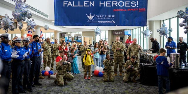 Families of fallen military members are welcomed to Snowball Express at the airport.