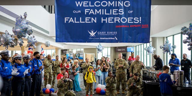 Families of fallen military members are welcomed to Snowball Express at the airport.