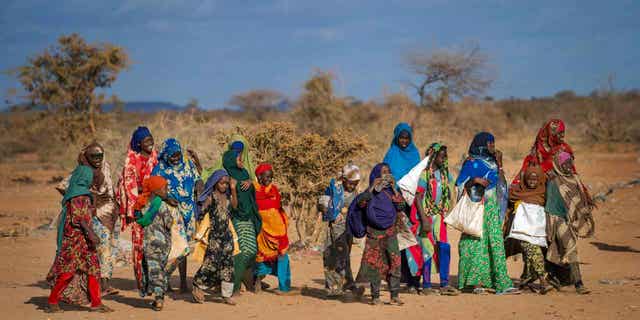 People arrive at a displacement camp on the outskirts of Dollow, Somalia, Sept. 19, 2022. 