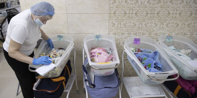 Newborns are seen in their cradles in Kiev, Ukraine March 17, 2022. Babies born to surrogates cannot be reunited with their biological families due to continued Russian attacks in Ukraine.