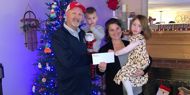 Tunnel to Towers CEO Frank Siller presents Connecticut mother Laura DeMonte and her two kids with the news that the mortgage on their house has been paid off.