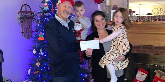 Tunnel to Towers CEO Frank Siller presents Connecticut mother Laura DeMonte and her two kids with the news that the mortgage on their house has been paid off.
