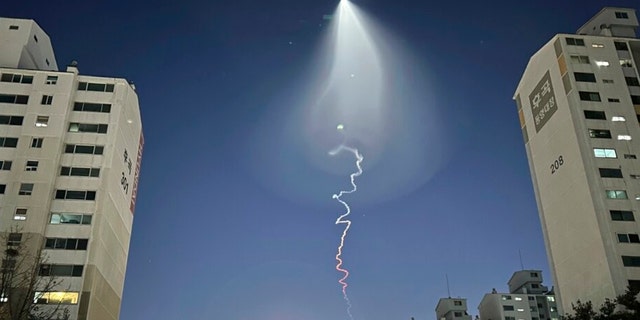 The light trail is seen in Goyang, South Korea, Friday, Dec. 30, 2022. South Korea's military confirmed it test-fired a solid-fueled rocket on Friday, after its unannounced launch triggered brief public scare of a suspected UFO appearance or a North Korean missile or drone flying. 