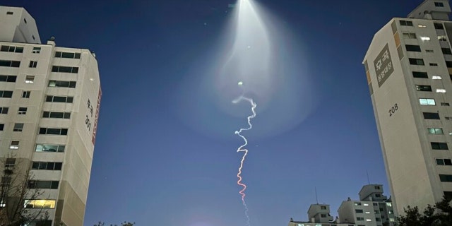 The light trail can be seen on Friday December 30, 2022 in Goyang, South Korea. South Korea's military confirmed it test-launched a solid-fuel rocket on Friday after its unannounced launch sparked a brief public fear of a suspected UFO appearance or other North Korean rocket or drone flying.