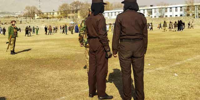 Taliban security personnel stand guard before the public flogging of women and men in Charikar city of Parwan province on Dec. 8, 2022. The Taliban flogged 27 Afghans, including women, in front of a large crowd on Thursday.
