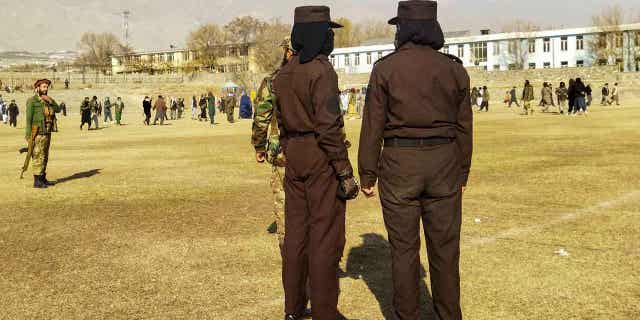 Taliban security personnel stand guard before the public flogging of women and men in Charikar town, Parwan province, Dec. 8, 2022. The Taliban flogged 27 Afghans, including women, on Thursday in front of a large crowd.