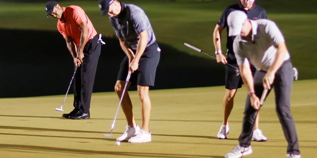 Tiger Woods of the United States putts under the feet of Jordan Spieth of the United States during The Match 7 at Pelican at Pelican Golf Club on December 10, 2022 in Belleair, Florida.