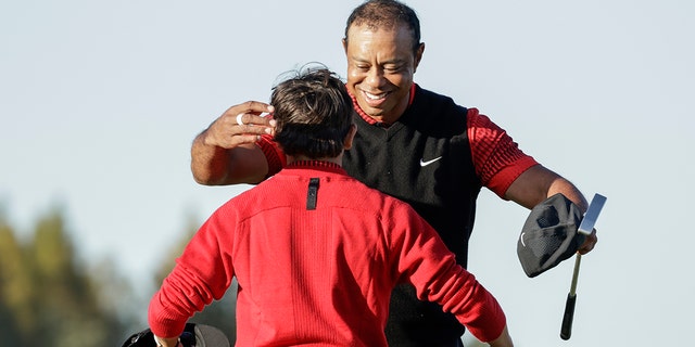 Tiger Woods hugs his son Charlie after finishing the 18th hole during the final round of the PNC Championship golf tournament in Orlando, Florida on Sunday.