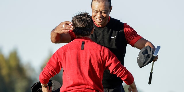 Tiger Woods hugs his son Charlie after finishing the 18th hole during the final round of the PNC Championship golf tournament in Orlando, Florida on Sunday.