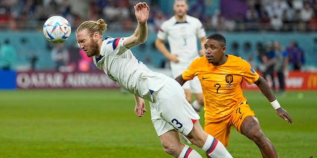 Tim Ream of the United States, left, is challenged by Steven Bergwijn of the Netherlands during the World Cup round of 16 soccer match between the Netherlands and the United States, at the Khalifa International Stadium in Doha, Qatar, Saturday, Dec. 3, 2022. 
