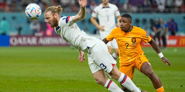 Tim Ream of the United States, left, is challenged by Steven Bergwijn of the Netherlands during the World Cup round of 16 soccer match between the Netherlands and the United States, at the Khalifa International Stadium in Doha, Qatar, Saturday, Dec. 3, 2022. 