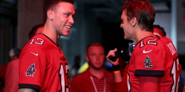 Aaron Judge talks with Tom Brady #12 of the Tampa Bay Buccaneers before the game.