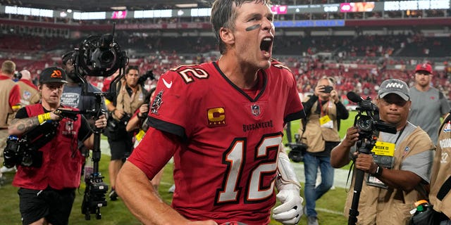 Tampa Bay Buccaneers quarterback Tom Brady, #12, reacts to the fans as he runs off the field after an NFL football game against the New Orleans Saints in Tampa, Florida, Monday, Dec. 5, 2022.