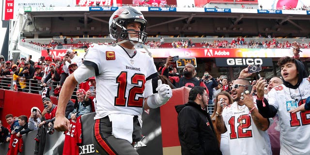 Tampa Bay Buccaneers quarterback Tom Brady runs onto the field before the team's NFL football game against the San Francisco 49ers in Santa Clara, California, Sunday, Dec. 11, 2022.