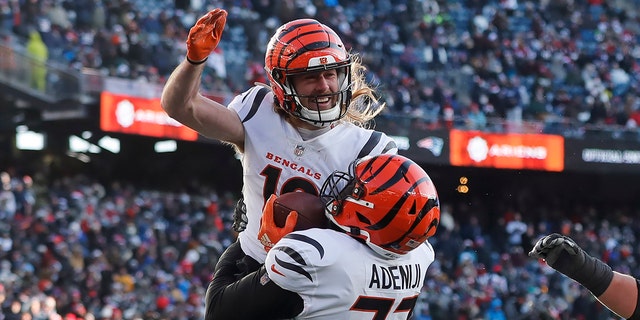 Cincinnati Bengals wide receiver Trenton Irwin, top, celebrates his touchdown with Cincinnati Bengals guard Hakeem Adeniji, #77, during the first half of an NFL football game against the New England Patriots, the Saturday, December 24, 2022, in Foxborough, Massachusetts.
