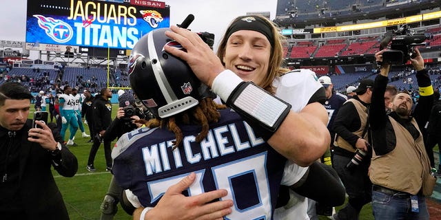 Jacksonville Jaguars quarterback Trevor Lawrence hugs Tennessee Titans cornerback Terrance Mitchell following the game on Sunday, Dec. 11, 2022, in Nashville, Tennessee.