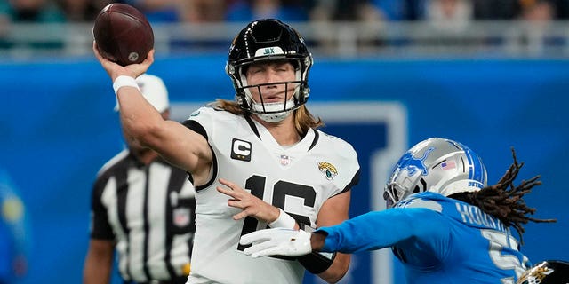 Jacksonville Jaguars quarterback Trevor Lawrence is pressured by Detroit Lions linebacker James Houston IV during the first half on Dec. 4, 2022, in Detroit.