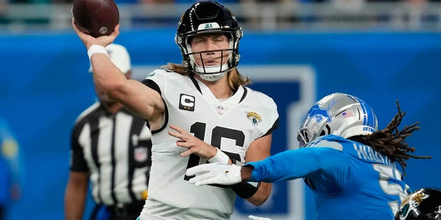 Jacksonville Jaguars quarterback Trevor Lawrence is pressured by Detroit Lions linebacker James Houston IV during the first half on Dec. 4, 2022, in Detroit.