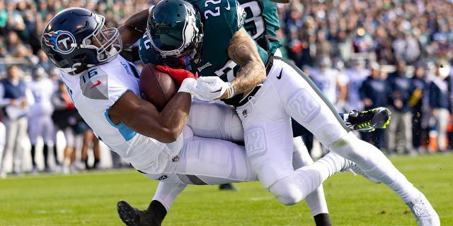 Tennessee Titans wide receiver Treylon Burks (16) is hit by Philadelphia Eagles safety Marcus Epps (22) as he makes a touchdown catch during the first quarter at Lincoln Financial Field in Philadelphia on Dec. 4, 2022.