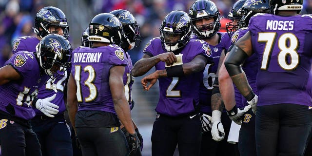 Baltimore Ravens players listen to Baltimore Ravens quarterback Tyler Huntley (2) in the second half of an NFL football game against the Denver Broncos, Sunday, Dec. 4, 2022, in Baltimore.