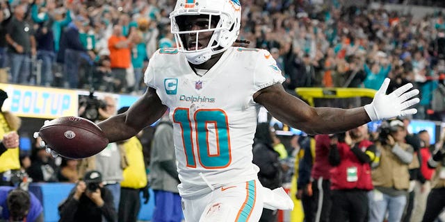 Miami Dolphins wide receiver Tyreek Hill scores a touchdown after recovering a fumble during the first half of a game against the Los Angeles Chargers on December 11, 2022 in Inglewood, California. 