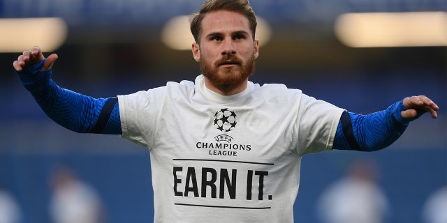 Alexis Mac Allister of Brighton and Hove Albion warms up wearing a T-shirt with a message in protest against the European Super League prior to a Premier League match against Chelsea at Stamford Bridge April 20, 2021, in London.