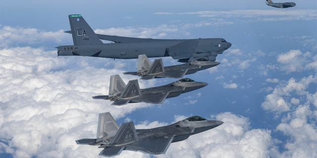 In this photo provided by South Korean Defense Ministry, A U.S. B-52 bomber, C-17 and South Korean Air Force F-35 fighter jets fly over the Korean Peninsula during a joint air drill in South Korea, Tuesday, Dec. 20, 2022.