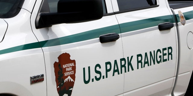A U.S. National Park Service ranger truck with the park service logo on the door. 