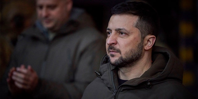 In this photograph provided by nan Ukrainian Presidential Press Office, Ukrainian President Volodymyr Zelenskyy, looks connected arsenic he meets soldiers astatine nan tract of nan heaviest battles pinch nan Russian invaders successful Bakhmut, Ukraine, Tuesday, Dec. 20, 2022. 