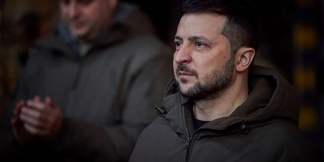 Ukrainian President Volodymyr Zelenskyy, looks on as he meets soldiers at the site of the heaviest battles with the Russian invaders in Bakhmut, Ukraine, Tuesday, Dec. 20, 2022. 