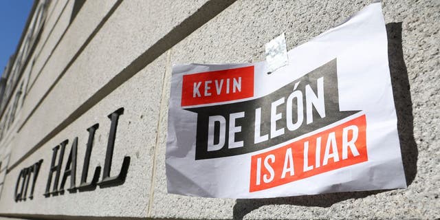 A sign denouncing Los Angeles City Council member Kevin de León is posted outside City Hall in the wake of a leaked audio recording.