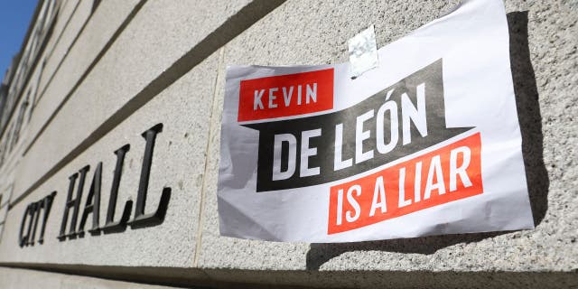 A sign denouncing Los Angeles City Council member Kevin de León is posted outside City Hall in the wake of a leaked audio recording.