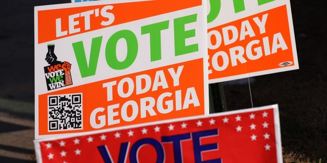 Signs encouraging people to vote are seen outside a polling station on Nov. 29 in Atlanta, Georgia.