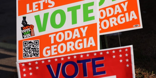 Signs encouraging people to vote are seen outside a polling station on Nov. 29 in Atlanta, Georgia.