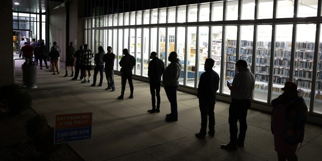 Residents wait in line to vote early outside a polling station on Nov. 29, 2022, in Atlanta.